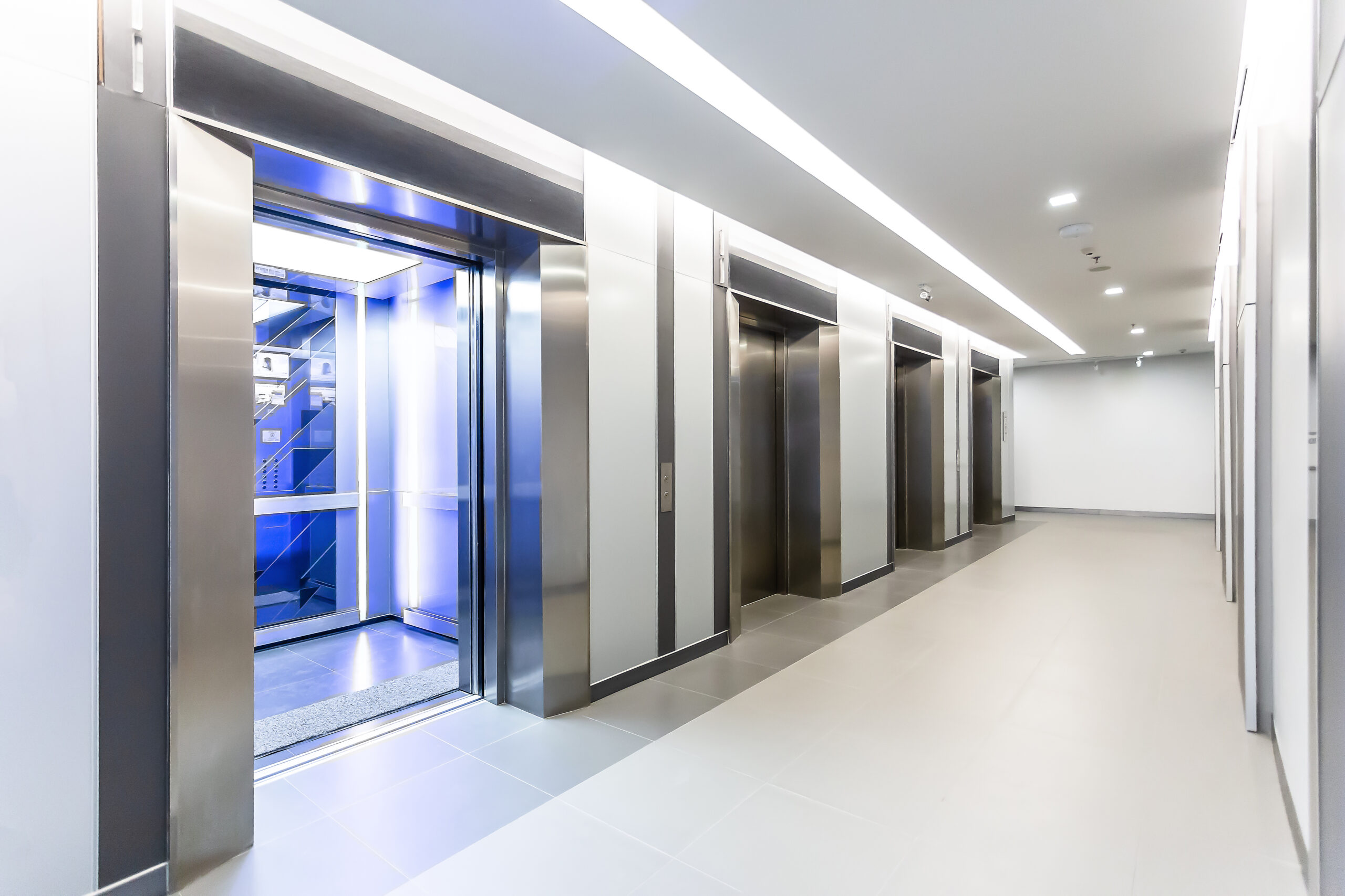 Modern steel elevator doors opened cabins in a business lobby or Hotel, Store, interior, office, perspective wide angle. Four elevators in hotel lobby.