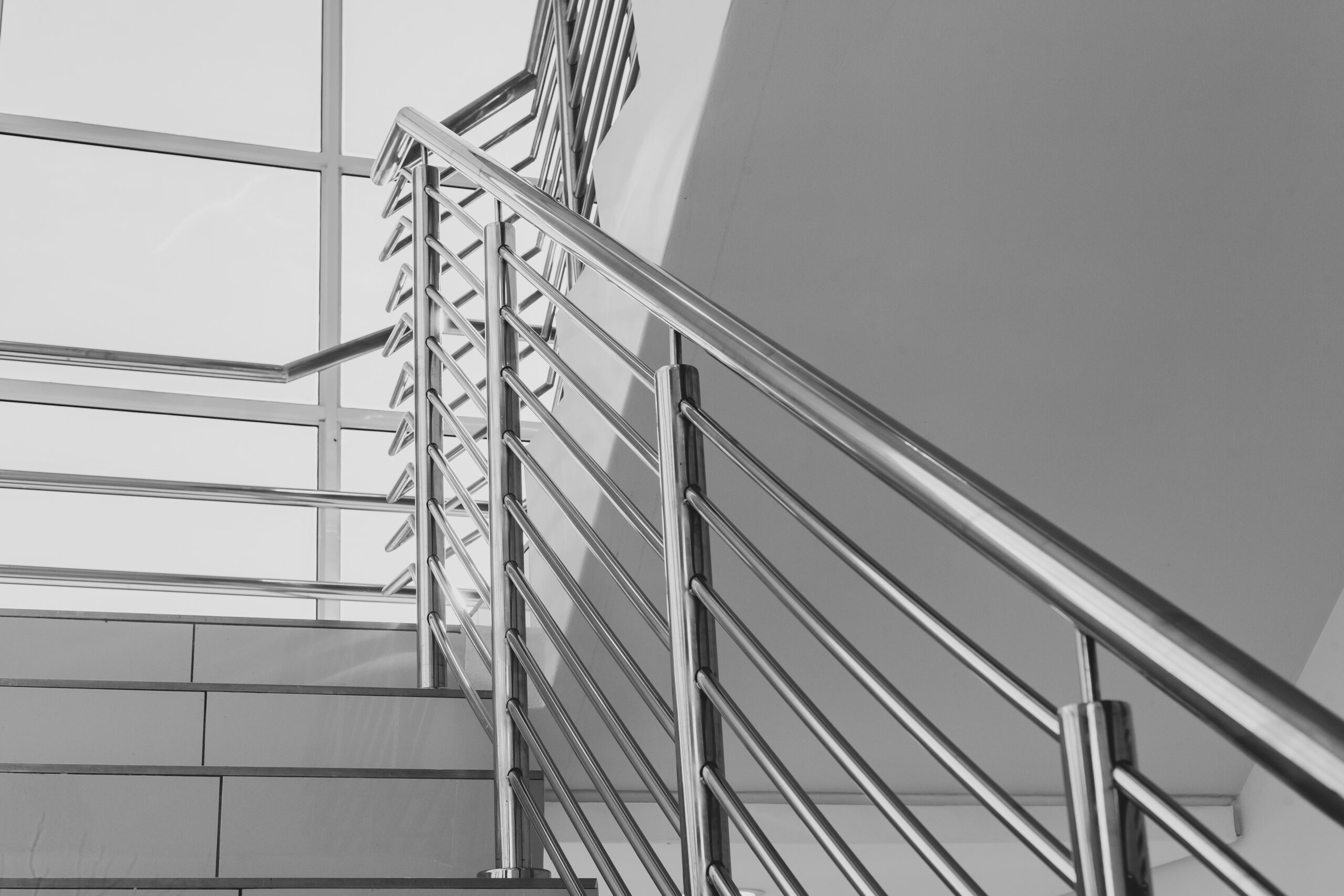 Building steps with stainless steel hand rail for public safety close-up decor design.