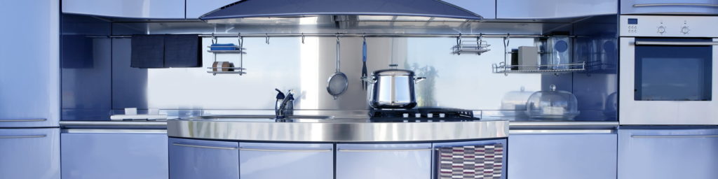 Modern kitchen with blue cabinets, stainless steel backsplash, built-in oven, stovetop with a pot, hanging utensils, and shelves holding kitchen essentials, all with sleek, contemporary design.